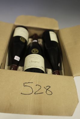 bottles of wine are in a cardboard box with a price tag