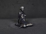 a statue of a woman sitting on the ground