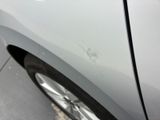 a close up of a car ' s front bumper with scratches on it