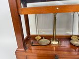 a wooden display case with two scales on it