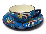 a close up of a cup and saucer on a plate