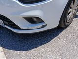 a white car that is parked on the side of the road
