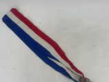 a red, white and blue ribbon with a tassel on it