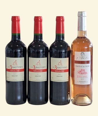 three bottles of wine sit next to each other on a table