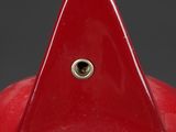 a close up of a red hat with a gold bird on it