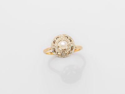 a gold ring with a pearl in the center