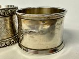 two silver cups sitting next to each other on a table