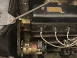 a close up of an old car engine with the hood open