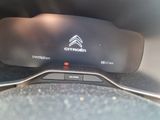 the dashboard of a car with a clock on it ' s display