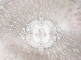 a silver tray with a decorative design on it
