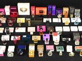 a lot of perfumes that are on a black table