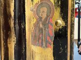 painting of a person holding an umbrella on a black and gold painted door