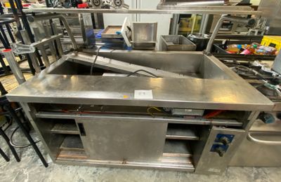 a large kitchen with a lot of stainless steel counter tops
