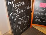 a chalk board that has a menu on it next to a chalk board
