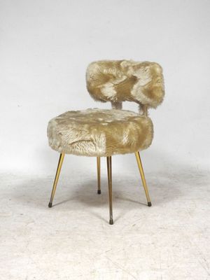 an image of a chair made of sheepskin with gold legs