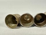 three silver cups sitting next to each other on a table