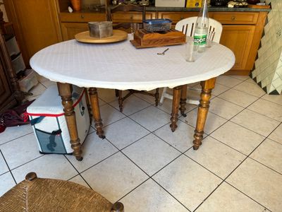 a table with a white table cloth on it in a kitchen