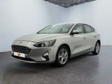 a silver car is parked in a white room