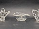 three glass vases sitting on top of a table next to each other