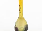 yellow and black vase on white background with trees in the background