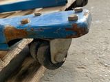 a blue piece of wood that is sitting on top of a pallet
