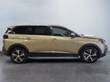 the gold suv is parked in a large room with a white wall