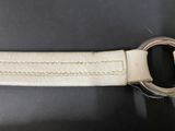a close up of a white leather belt with a metal buckle