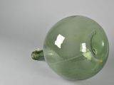 a green glass vase with a hole in the middle