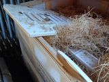 a pile of hay inside of a small chicken coop