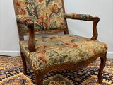 an old chair with a floral upholstered seat