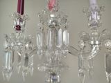 three crystal candles that are hanging from a chandelier