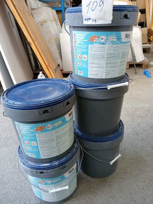 three buckets of paint sitting next to each other on the floor