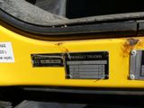 a close up of a sign on the back of a yellow truck