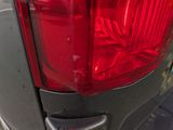 a close up of a car ' s tail light on the street