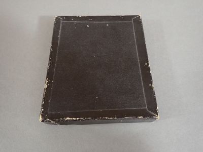 a small black book sitting on top of a table