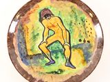 a plate with a painting of a man on it