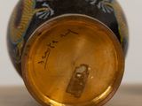 a close up of a vase with a dragon on it