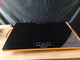 a black and orange stove top on a wooden table