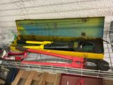 some tools are sitting on top of a metal shelf