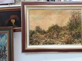 many paintings hanging on the wall next to each other