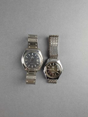 two watches that are sitting next to each other on a table