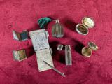 a lot of silver items that are on a red cloth