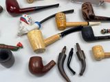 many different types of smoking pipes on the table