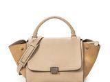 a beige handbag on a white background with a strap