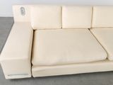 a white couch that is sitting on a concrete floor