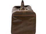 the large brown bag is sitting on a white surface