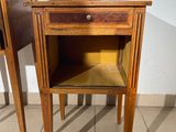 two wooden tables with drawers on them on a tiled floor