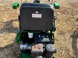 an image of a lawn mower parked in a field