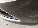 a close up of a car ' s front bumper with a hole in it