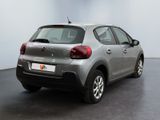 the back of a silver citrole parked in a white room
